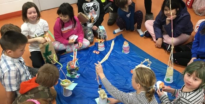 kids sitting on the floor doing crafts